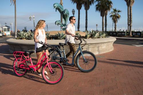 a man and a woman with their bikes in front of a fountain at Haley Hotel in Santa Barbara
