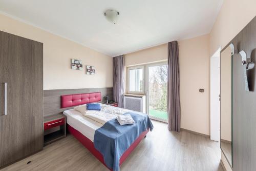 a bedroom with a bed and a window at Hotel Klein Frankfurt in Frankfurt/Main