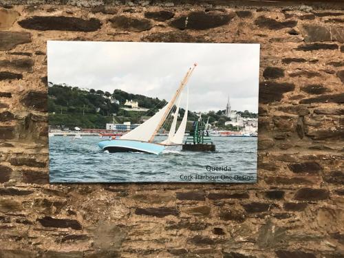 a picture of a sail boat on the water at Redington House SelfCatering accommodation in Cobh