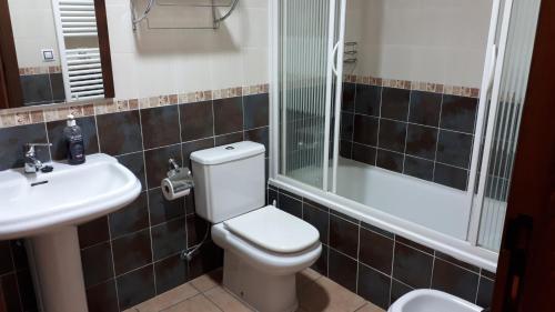 y baño con aseo, lavabo y ducha. en Casa Tere, en Orihuela del Tremedal