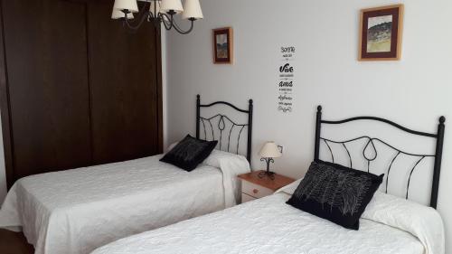 two beds sitting next to each other in a room at Casa Tere in Orihuela del Tremedal