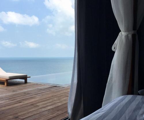 a room with a bed and a view of the ocean at St Barth Villas in Salad Beach