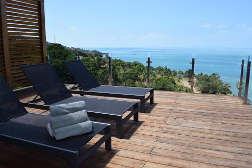 a group of chairs sitting on top of a deck at St Barth Villas in Salad Beach