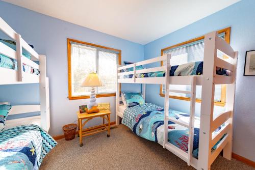 two bunk beds in a room with blue walls at Duck R Way in Duck