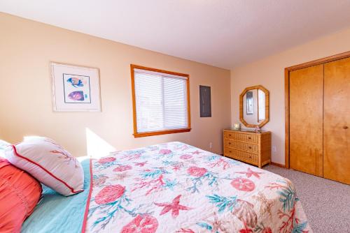 a bedroom with a bed and a dresser and a mirror at Duck R Way in Duck