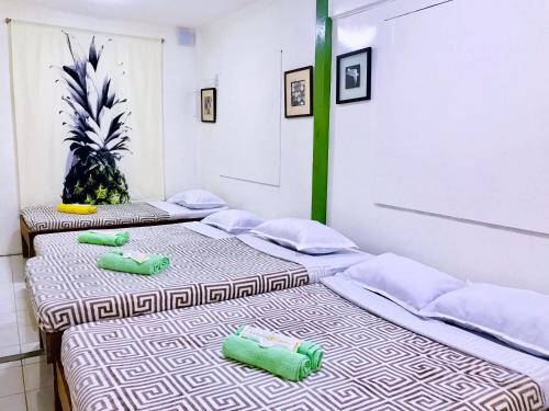two beds sitting next to each other in a room at Lanzones Cabana in Mambajao