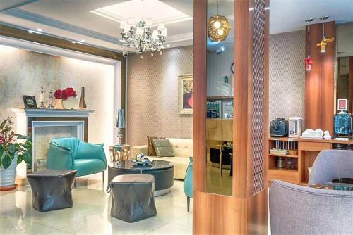 a living room with a couch and a table and chairs at Taitung Z. Hotel in Taitung City