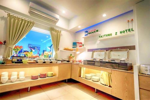 a kitchen with a counter with dishes on display at Taitung Z. Hotel in Taitung City