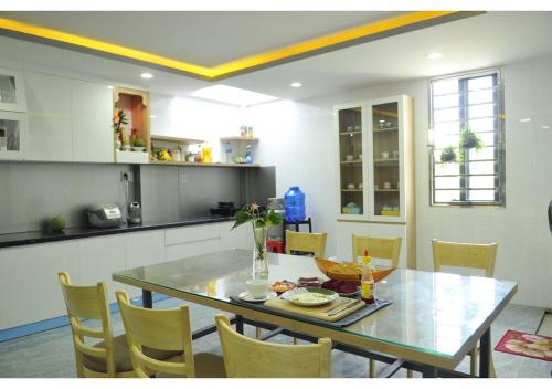 a kitchen and dining room with a table and chairs at Cherry Hotel Bến Lức in Bến Lức