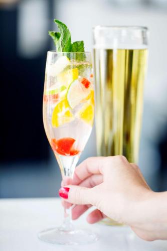 a hand holding a glass with a drink at Hyatt House Charlotte Center City in Charlotte