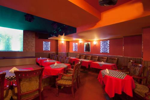 a restaurant with tables and chairs with red table cloth at Al Sarab Hotel in Dubai
