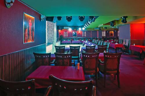 a dining room with red tables and chairs at Al Sarab Hotel in Dubai