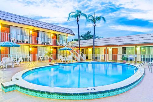a swimming pool in front of a hotel at Days Inn by Wyndham St. Petersburg Central in St. Petersburg