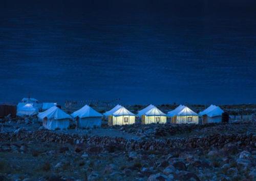 a group of tents in a field at night at The Buddha Camp - Pangng in Spangmik