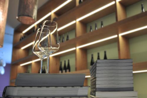 a glass of wine sitting on a stack of books at Heitlinger Hof in Tiefenbach