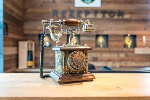 a phone sitting on top of a table at Hotel Haunstetter Hof Augsburg in Augsburg