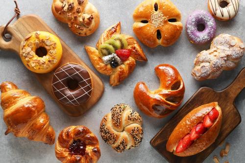 a bunch of different types of donuts on a table at Kerry Hotel, Beijing by Shangri-La - 5 Kilometers to The Forbidden City in Beijing