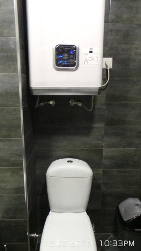 a bathroom with a toilet with a camera on the wall at Orbi Plaza 4 & New Boulevard in Batumi
