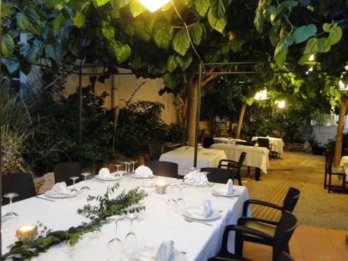 a table set up for a meal in a restaurant at Hotel Restaurant Llansola in Sant Carles de la Ràpita