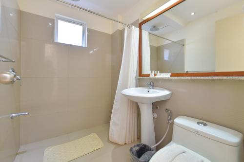 a bathroom with a sink and a toilet and a shower at Signature Boracay South Beach in Boracay