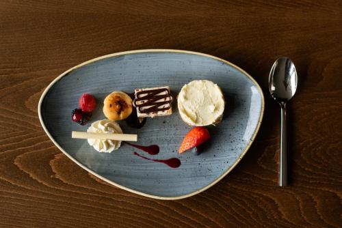 a plate of food with ice cream and strawberries at The Hoban Hotel Kilkenny in Kilkenny
