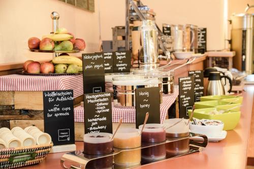 a counter with different types of food on at JUFA Hotel Leibnitz in Leibnitz