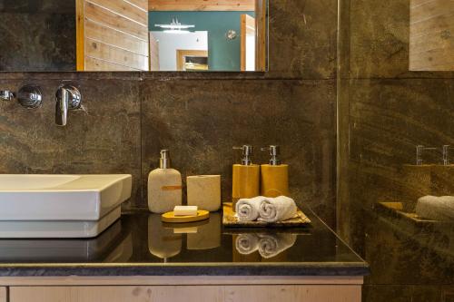a bathroom with a sink and a counter with towels at Rakkh Resort, a member of Radisson Individuals Retreats in Pālampur