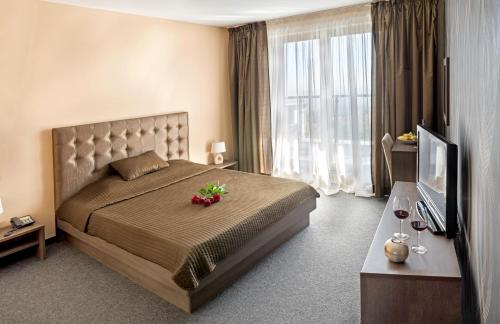 a bedroom with a large bed with flowers on it at Face Hotel in Sofia