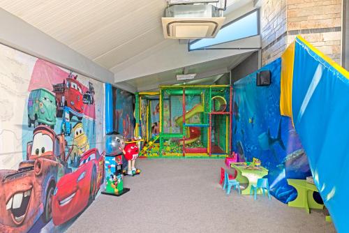 a room with a play room with a mural on the wall at Face Hotel in Sofia