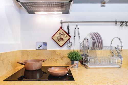 a kitchen with two pots and pans on a stove at Appartamento la Ninfea in Florence