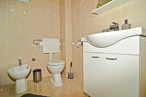 a bathroom with a sink and a toilet at Apartman Nina in Zadar