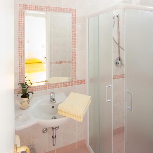 a bathroom with a sink and a shower at Hotel Altair in Misano Adriatico