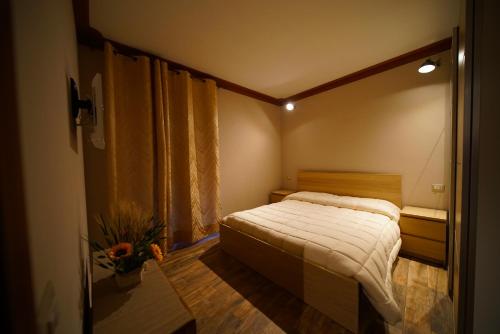 a small bedroom with a bed and a window at CASA VACANZE DA SIRA in Marta