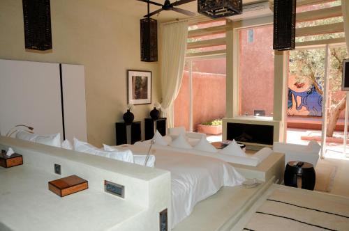 a bedroom with a large white bed and a window at Dar Sabra in Marrakech
