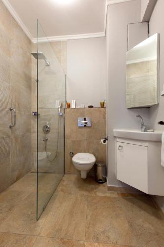 a bathroom with a shower and a toilet and a sink at Queen Seagull Boutique Hotel in Istanbul