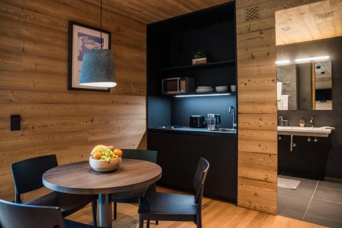 a kitchen and dining room with a table and chairs at Riffelalp Lodge in Sankt Anton am Arlberg