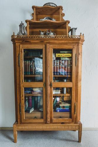 a wooden cabinet filled with books at Gasthof Kornbachtal in Gefrees