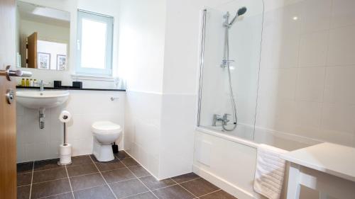 a bathroom with a toilet and a sink and a shower at The Highland Club in Fort Augustus