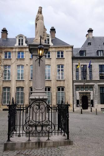 a statue sitting on top of a gate in front of a building at The View - spacious 2 bdr appt in with view in Antwerp