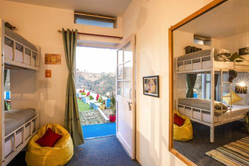 a bedroom with bunk beds and a mirror at Zostel Mukteshwar in Mukteswar