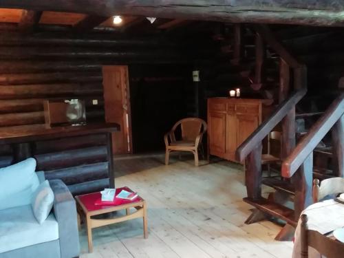 a living room with a couch and a table at Chalet near Lake and Pool in Quend-Plage in Quend