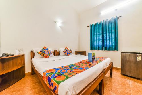 a bedroom with two beds and a dresser in it at FabHotel Yoyo Cottage With Pool, Chapora Fort in Vagator