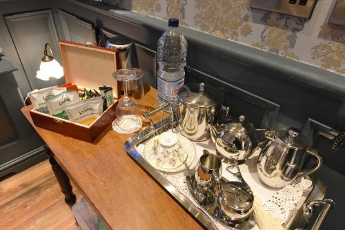 a table with a tray of silver dishes on it at The Aston Tavern in Birmingham