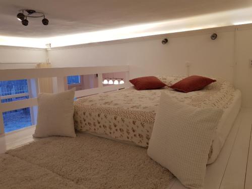 a bedroom with a bed with two pillows on it at Brand New Garden Flat / Free Parking in Budapest