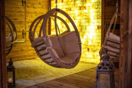 a room with two hanging chairs in a room at Gold Hotel in Zakopane
