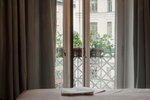 a bedroom with a window looking out onto a balcony at The Sparrow Hotel in Stockholm