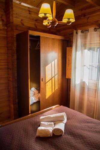 a bedroom with a bed with two towels on it at xisto camping in Janeiro de Baixo