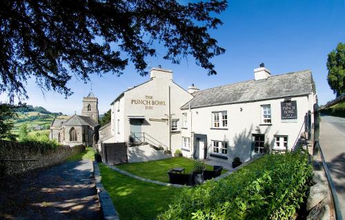 a white building with a church in the background at The Punch Bowl Inn in Kendal