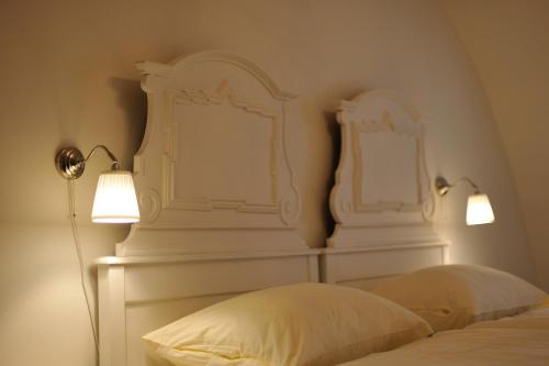 a bedroom with two white headboards on the wall at Zámek Nové Město nad Metují in Nové Město nad Metují