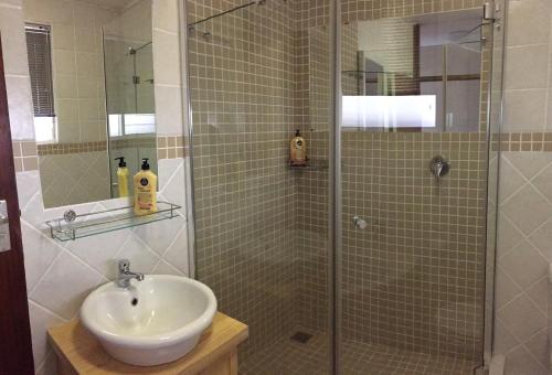 a bathroom with a shower and a sink at C-Rus in Strand